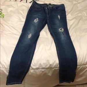 Jeans with rips and zippers on the bottom legs